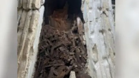 Brighton & Hove Museums Rotten brown wood inside a grey stone render turret or dome