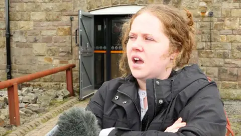 Woman being interviewed about museum charges