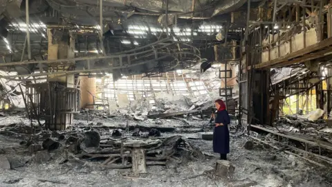BBC correspondent Lyse Doucet in the ruins of a television studio in Tehran