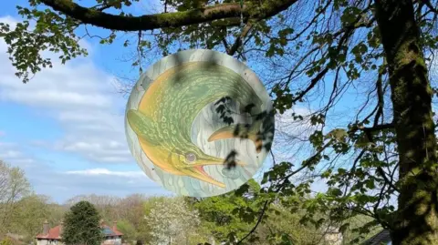 BUXTON An ichthyosaur on one of the signs on Thomas's Trail in Grin Low Woods in Buxton