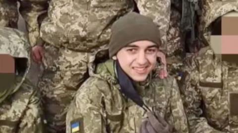 Brahim smiling in the middle of other soldiers in Ukrainian uniform