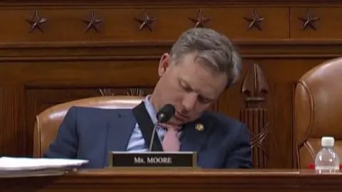 Representative Blake Moore asleep in his chair