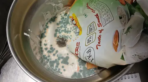 Cardiff Council A bowl of a mouldy cream-like liquid with a bag of white rice dipped into it.