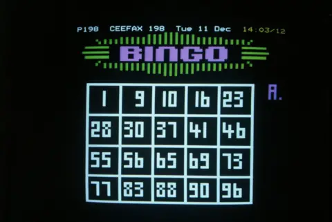 A black Ceefax page with a white bingo grid filled in with numbers and above it in purple letters the word Bingo, surrounded by green lines