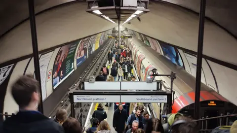 Getty Images Stock image of passengers getting off a London Underground tube train onto the island narrow platform at Clapham Common tube station.