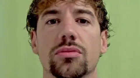 Police mugshot of Kane Jones, who has brown hair and a goatee.