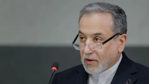 A headshot of Abbas Araghchi as he speaks into a microphone.