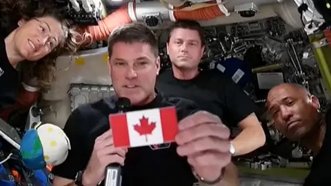 The Artemis astronauts show off the Canadian flag patch.