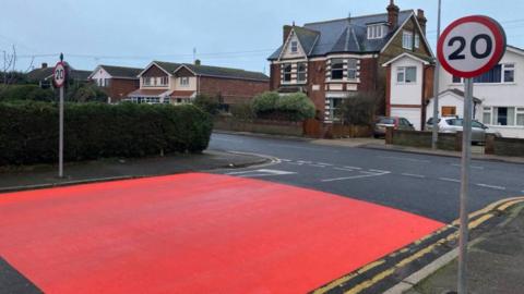 A section of road junction painted bright red
