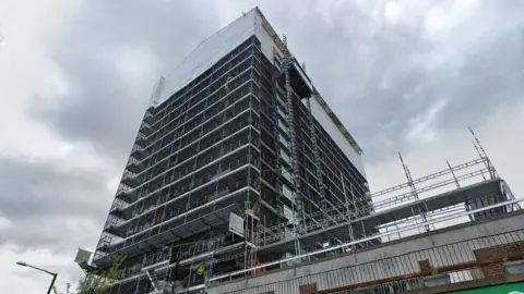 Scaffolding completely covering the exterior of Gilton House during a renovation to remove the flammable cladding. 