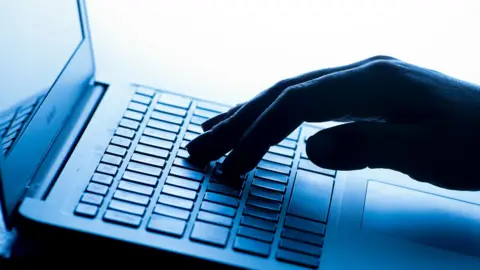 PA Media Anon person typing