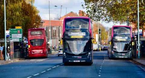 BBC Three buses on a road