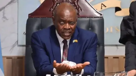 Botswana's President Mokgweetsi Masisi holding diamond