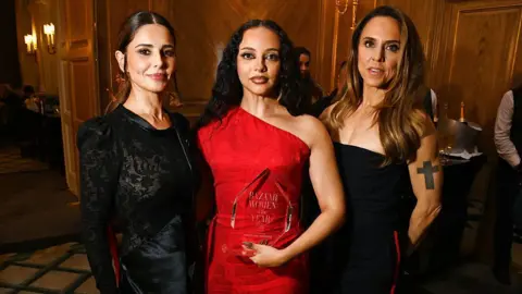 Getty Images  (L to R) Cheryl, Jade Thirlwall, winner of the Musician award, and Melanie C aka Sporty Spice pose in the winners room at the 2025 Harper's Bazaar Women of the Year Awards,