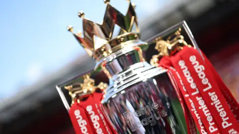 The Premier League trophy dressed in red ribbons