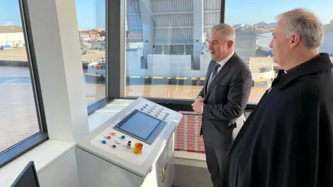 Shaun Whitmore/BBC Brandon Lewis in the control room of the new Herring Bridge