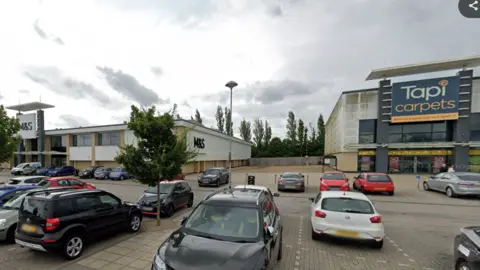 Google Car park view of M&S at Brotherhood Shopping Park and the empty space between in and Tapi.