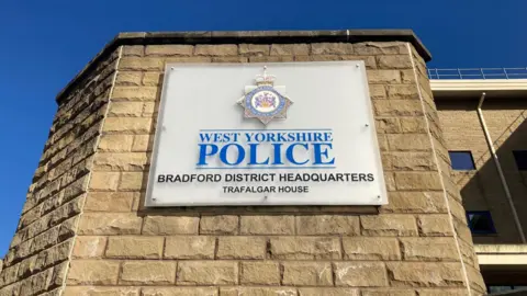 A sign spelling out West Yorkshire Police and Bradford District Headquarters, Trafalgar House.