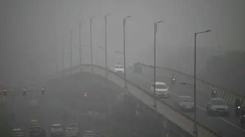 AFP Commuters drive through dense smog in New Delhi on November 13, 2024. India's capital, New Delhi, was engulfed in toxic smog on November 13 as air pollution exceeded the World Health Organization's 50-fold threshold. An organization that recommended it every day.