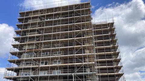 A tower block covered in scaffolding