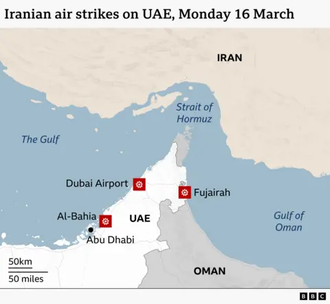 A map showing the countries in the Middle East around the Strait of Hormuz with Iran to the north of the strait and UAE and Oman to the south. Marked in the UAE are three locations which reported being hit by air strikes on Monday 16 March. Two locations are on the west coast: Dubai Airport and the area of Al-Bahia, which lies just outside the capital city of Abu Dhabi. The other location is Fujairah on the east coast.