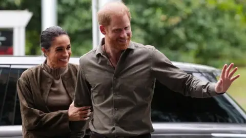 Reuters Prince Harry and Meghan waving as they arrive at the Australian National Veterans Arts Museum in Melbourne, Australia on 14 April 2026.