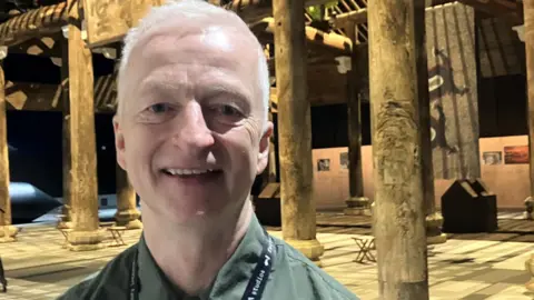Photograph of John McGrath from Factory International. He is pictured at the Ai Weiwei exhibition at Manchester's Aviva Studios.