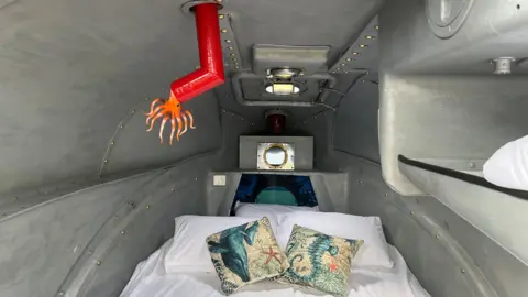 A bed inside the glamping submarine at Cheddar