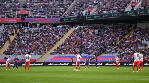 Football players standing on pitch