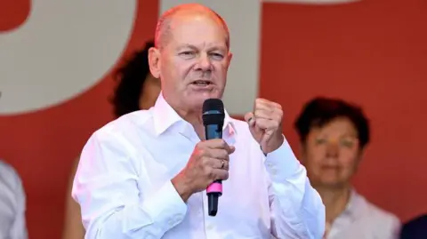 Reuters German Chancellor Olaf Scholz speaks at a Social Democratic Party (SPD) campaign rally for the Thuringia state elections on August 27, 2024 in Jena, Germany.