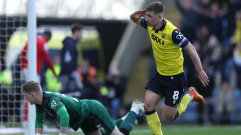 PA Media Oxford United's Cameron Brannagan celebrates scoring their side's first goal of the game from the penalty spot during the Sky Bet Championship match at the Kassam Stadium, Oxford.