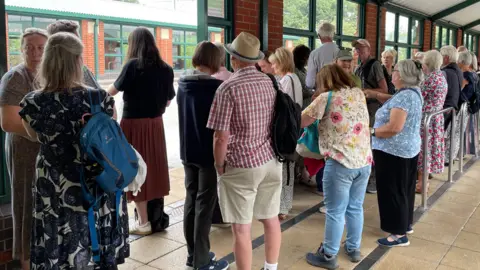 A queue of ticket-holders for the event at the Meadowhall Interchange coach station.