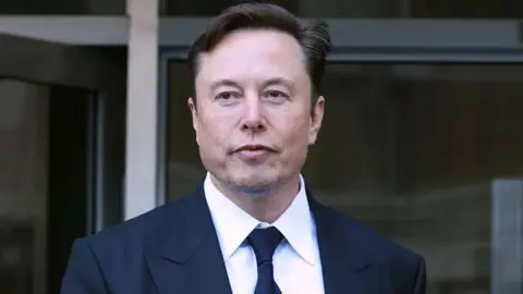 Getty Images Elon Musk wearing a suit and tie