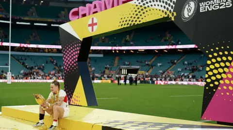 Getty Images Megan Jones of England with the trophy following victory in the Women's Rugby World Cup 2025 Final 