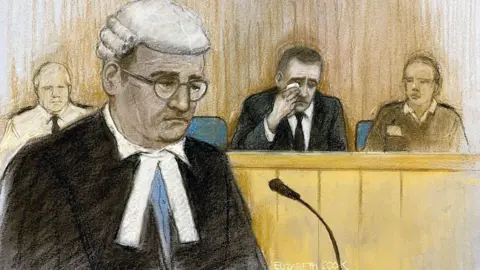 PA Media Court artist sketch by Elizabeth Cook of prosecution counsel Paul Greaney KC speaking as Paul Doyle, wipes away tears as he appears at Liverpool Crown Court