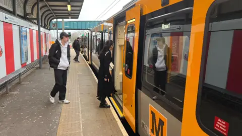 The new Tyne and Wear Metro train on its first journey through Sunderland, pictured at the Stadium of Light with people alighting the train.