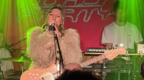 Another shot from the gig. The lead singer is wearing a white fur coat.