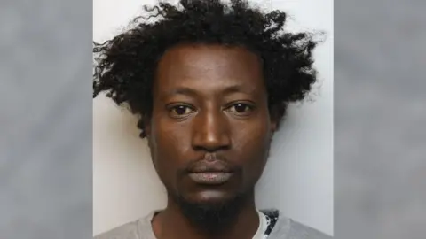 A mugshot of 35-year-old Abdul Hamed, who is wearing a light grey jumper.