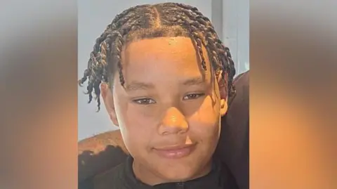 Wivenhoe Town FC/ Facebook A close up of Taylen who is smiling and looking at the camera. He a middle parting has twist plaited hair to his ear and brown skin