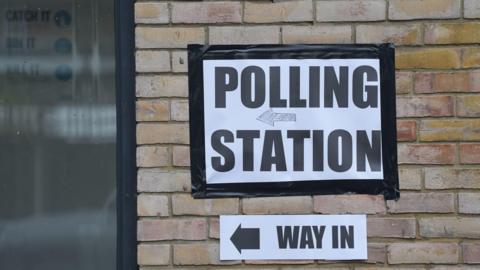 A stock image of a polling station sign