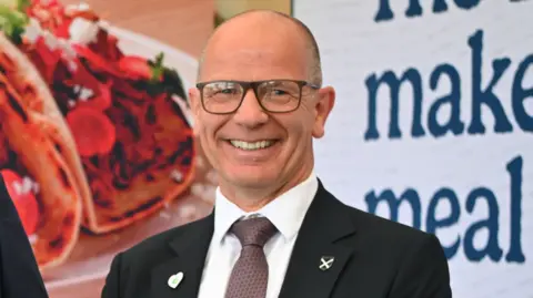 Getty Images Agriculture Minister Jim Fairlie, a bald-headed man with glasses in a suit and tie with a white shirt