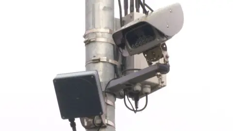 A noise camera attatched high up an a street lamp in Exmouth