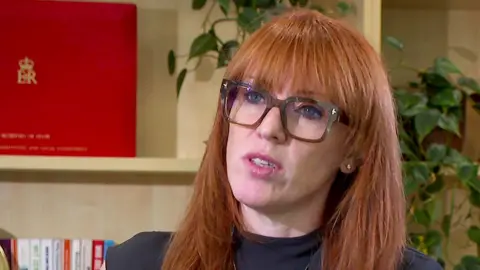 A grab from video shows a head and shoulders shot of Angela Rayner wearing glasses while speaking in an interview with the BBC.