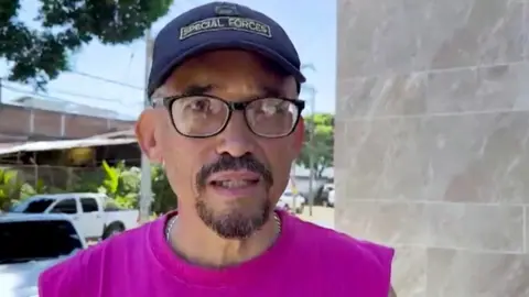 A man is talking to a reporter after the earthquake.