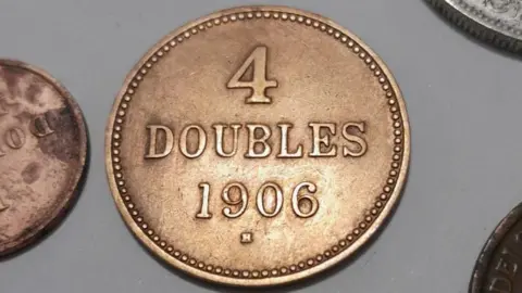 Paul Stockreiter A Guernsey 4 Doubles coin from 1906. It is copper in colour reflecting signs of use.