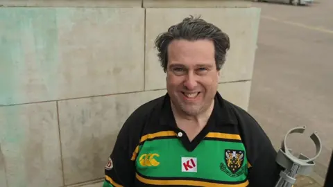 Stephen Huntley/BBC Phillip Grisewood in a Northampton Saints shirt