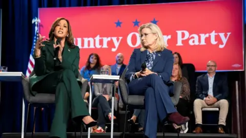 Getty Images Harris and Cheney sat together in a hall in Royal Oak, Michigan