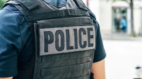 Getty Images “Police” written on the back of a blue French police uniform