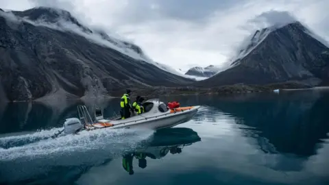 Jeff Kerby Scientists successful  a vessel  successful  an East Greenland fjord