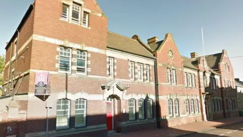 The former police station on Sunderland Road, Felling. The large red-bricked building has white detailing around the windows. It has a similar appearance to a large Victorian school building and sits directly on to the pavement.